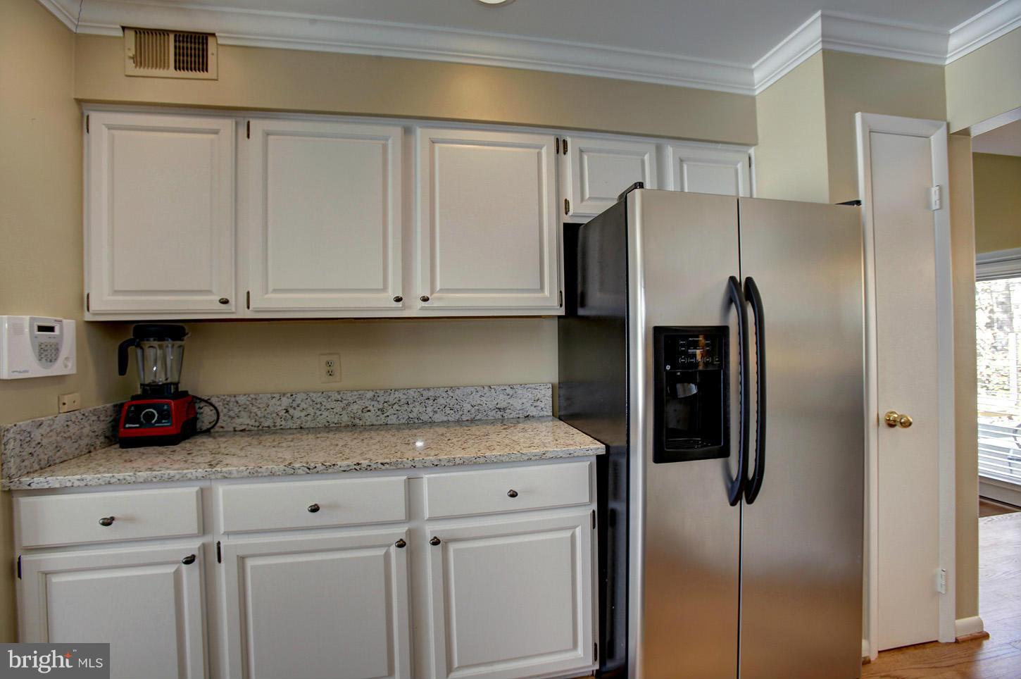 11632 Chapel Cross Way Reston, VA 20194 - Photo 16 of 30 a kitchen with stainless steel appliances granite countertop a refrigerator and white cabinets