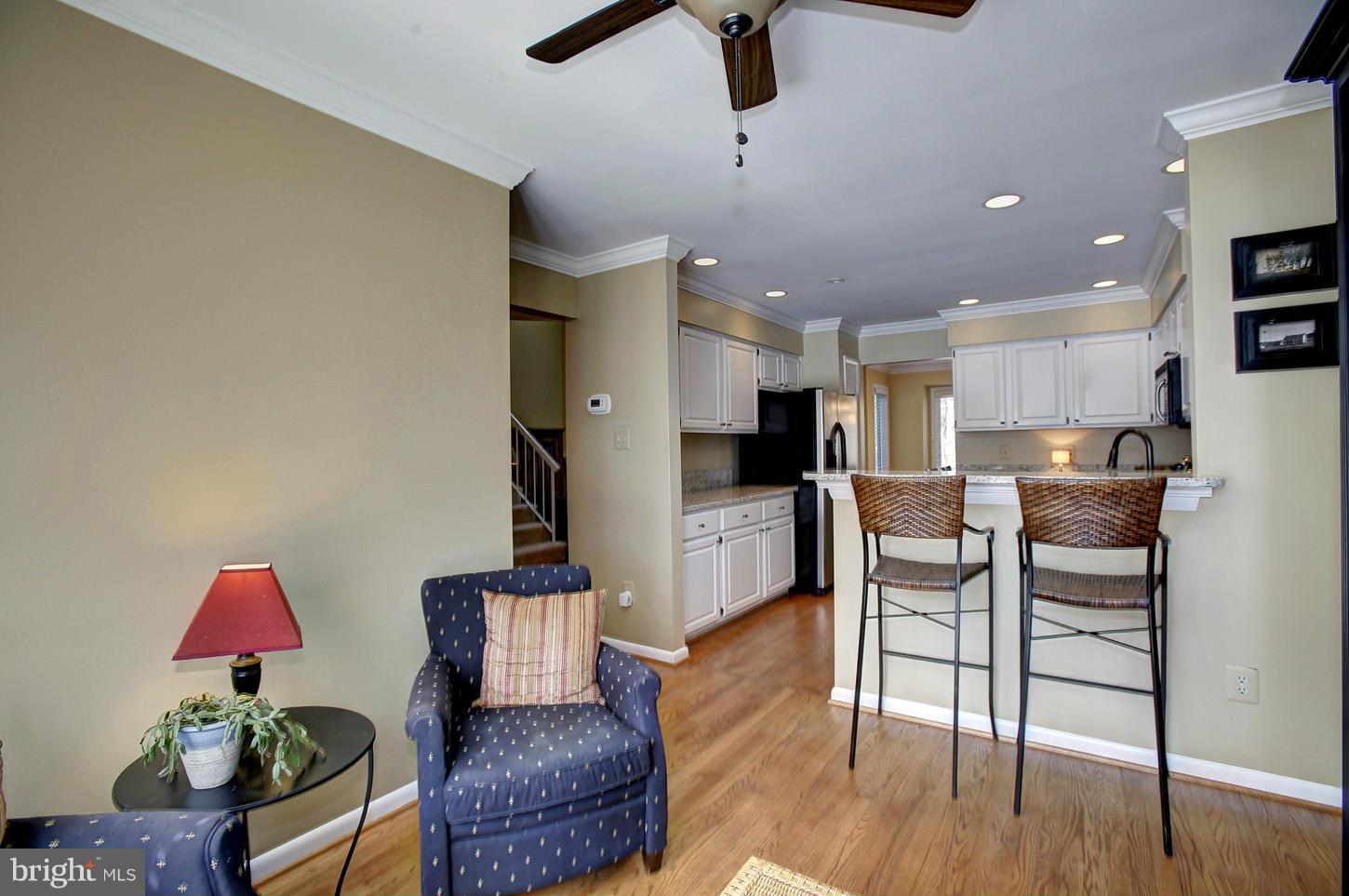 11632 Chapel Cross Way Reston, VA 20194 - Photo 17 of 30 a living room with furniture and a kitchen view