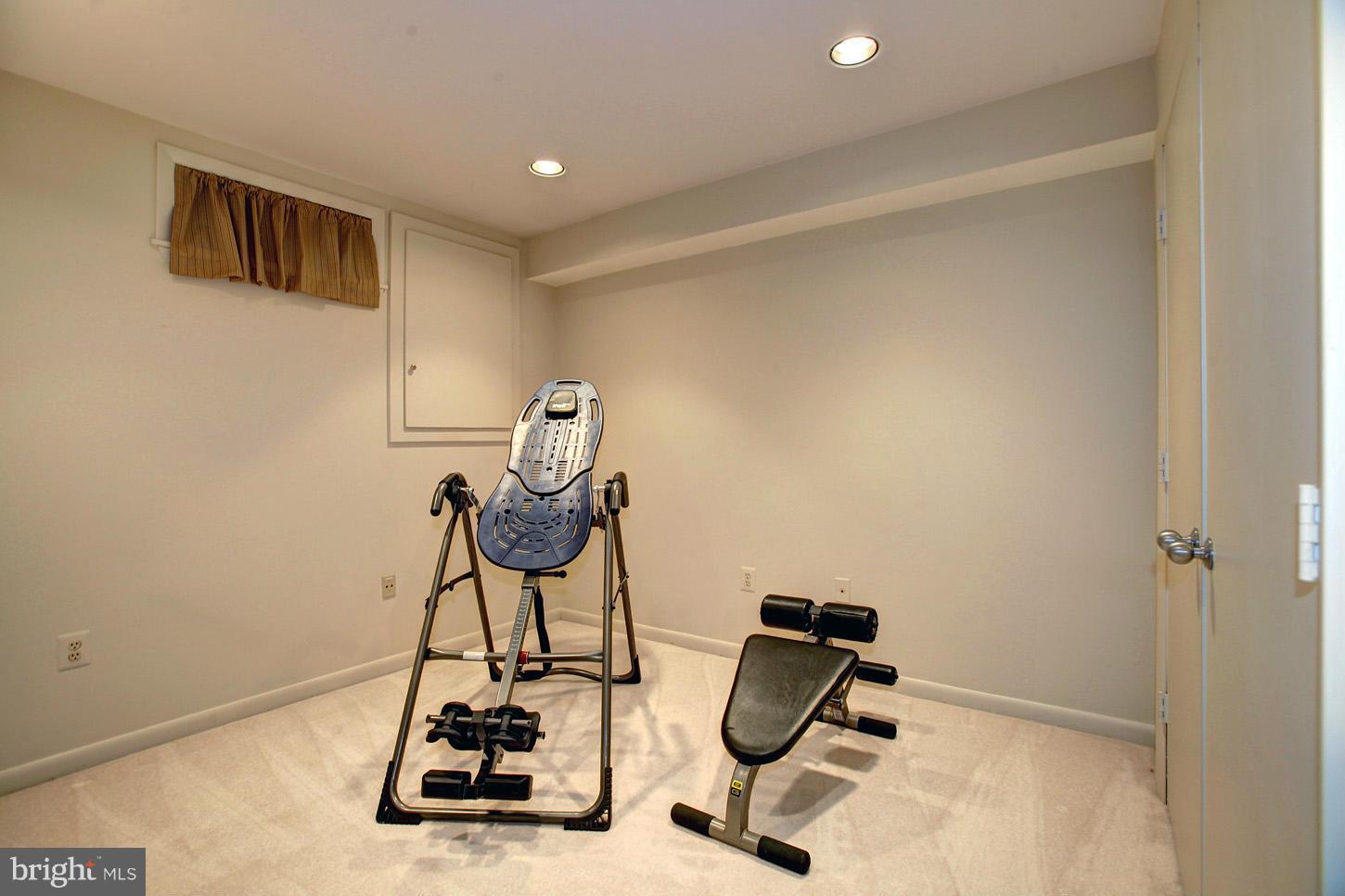 11632 Chapel Cross Way Reston, VA 20194 - Photo 26 of 30 a room with gym equipment and white walls
