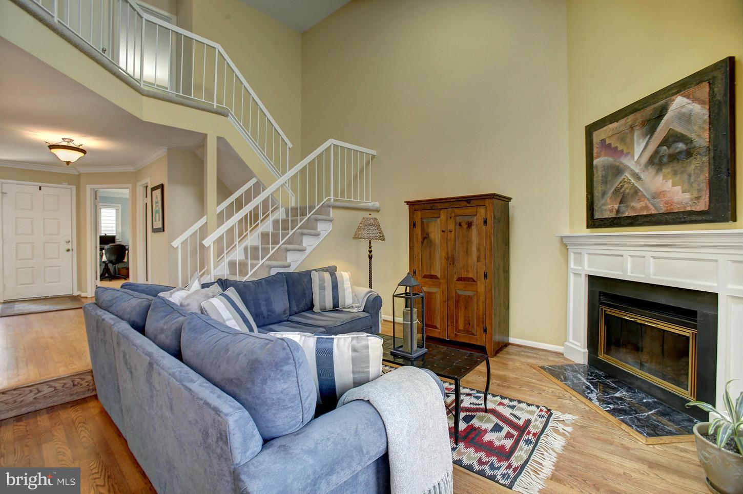 11632 Chapel Cross Way Reston, VA 20194 - Photo 7 of 30 a living room with furniture a fireplace and a flat screen tv