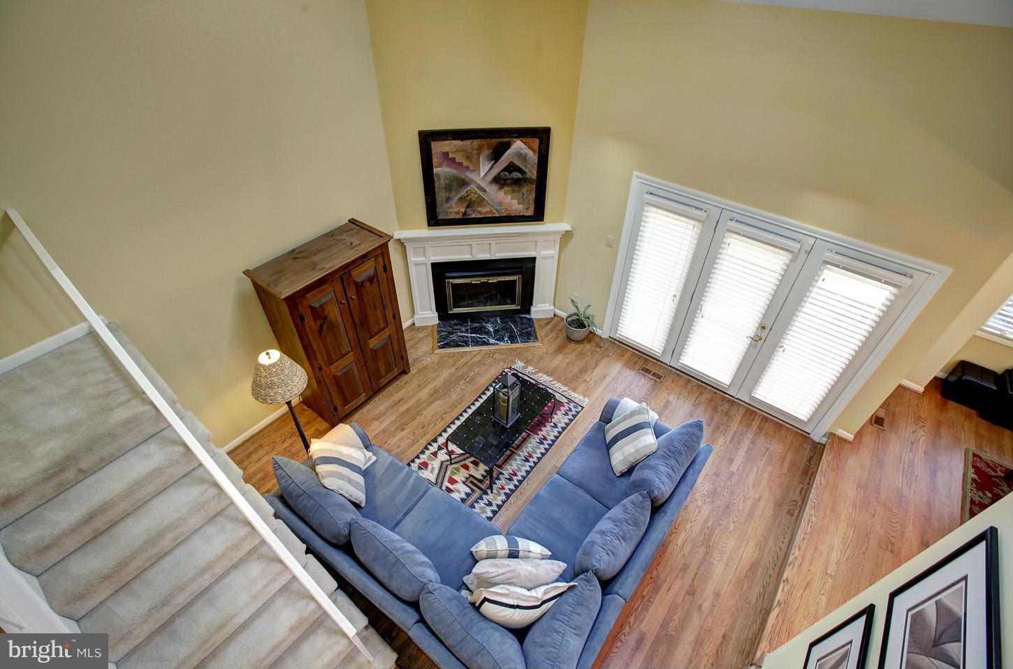11632 Chapel Cross Way Reston, VA 20194 - Photo 8 of 30 a living room with furniture and a fireplace