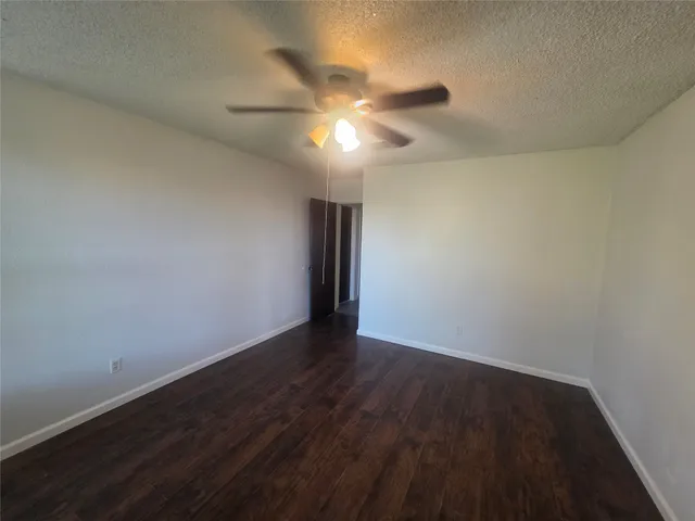 a view of an empty room and wooden floor
