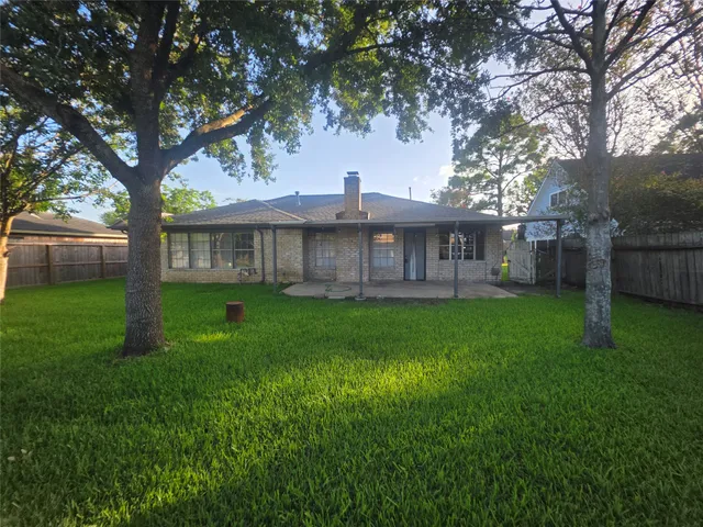 a view of a house with a yard and sitting area
