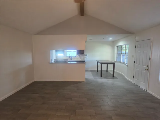 a view of a livingroom with furniture and a window