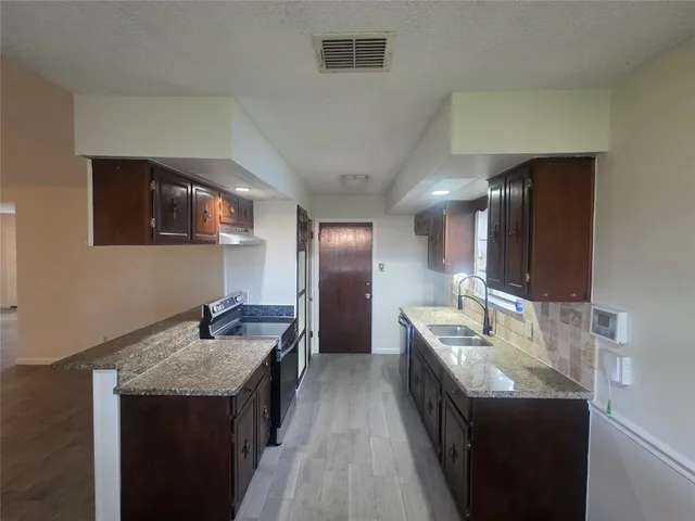 a bathroom with a sink double vanity granite and a mirror