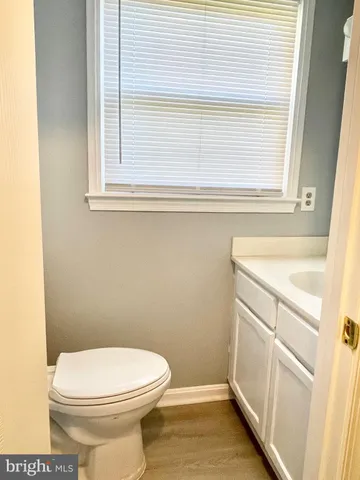 a bathroom with a sink a toilet and a window