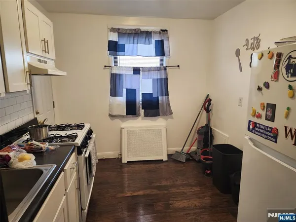 a kitchen with a refrigerator and cabinets