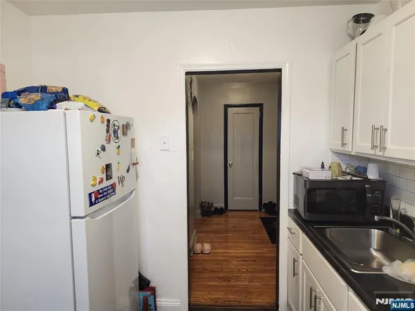 a kitchen with stainless steel appliances a sink stove and refrigerator