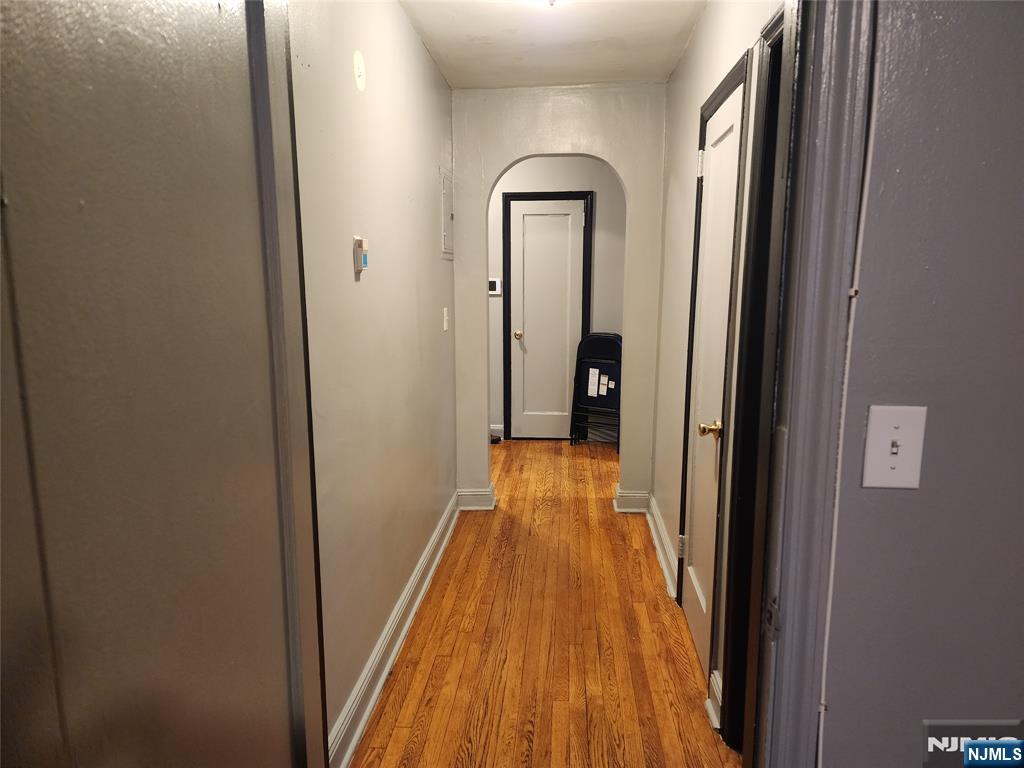 490 Beverly Road, Unit B6 Teaneck, NJ 07666 - Photo 9 of 17 a view of a hallway with wooden floor and a bathroom