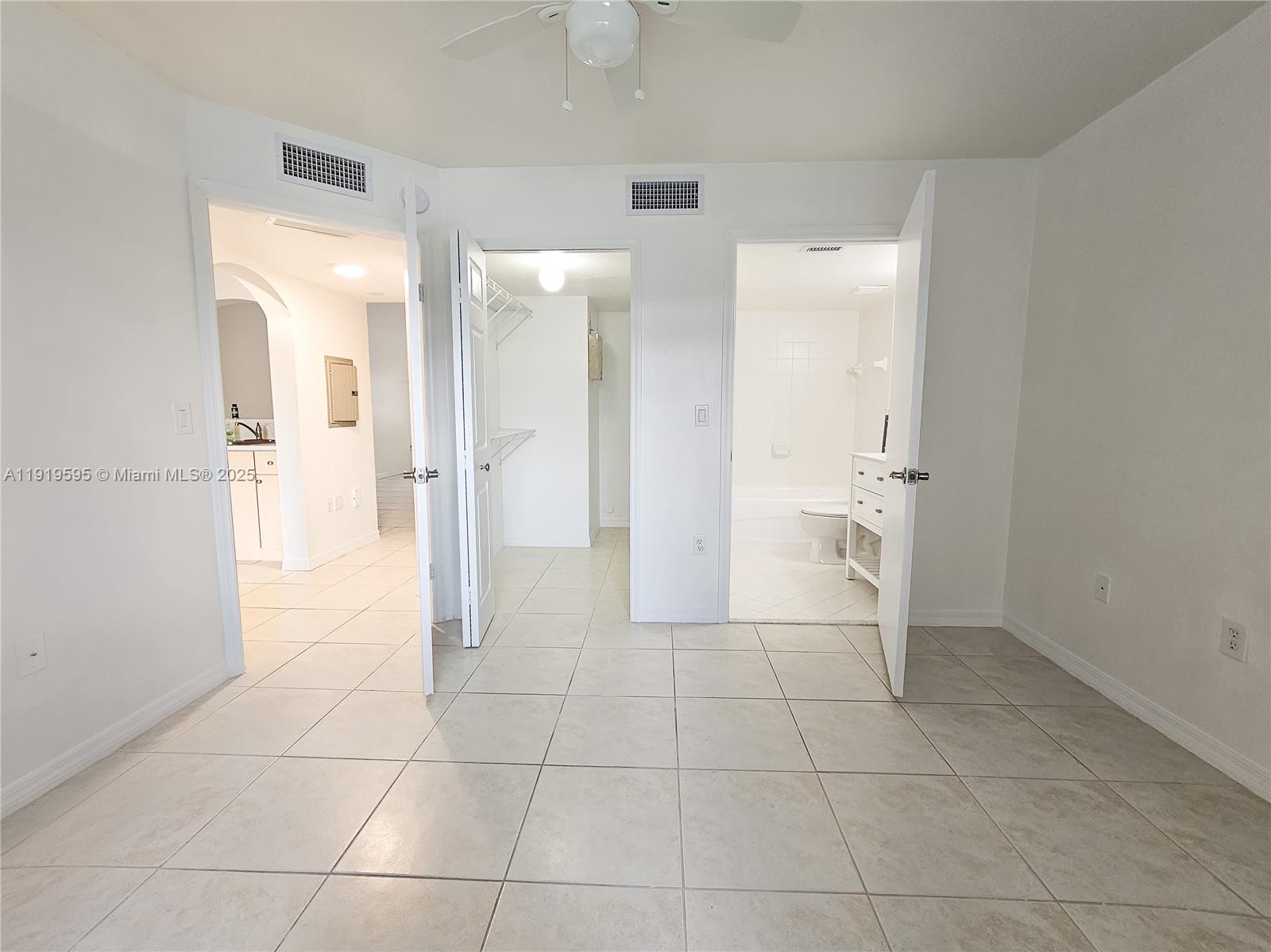 2651 Southeast 12th Road, Unit 105 Homestead, FL 33035 - Photo 13 of 24 a bathroom with a glass door shower a sink and a mirror