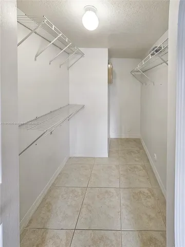 a view of a storage and utility room with closet