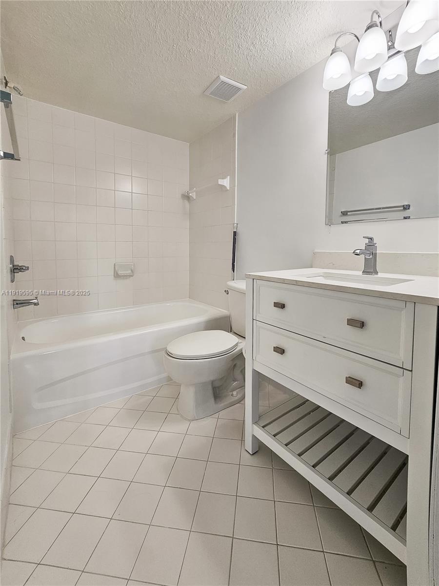 2651 Southeast 12th Road, Unit 105 Homestead, FL 33035 - Photo 15 of 24 a bathroom with a sink a toilet and bathtub