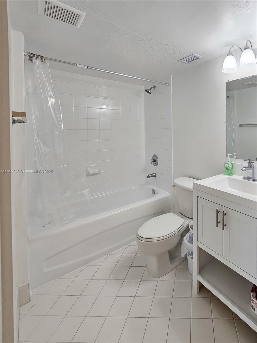 2651 Southeast 12th Road, Unit 105 Homestead, FL 33035 - Photo 20 of 24 a bathroom with a sink a toilet and shower