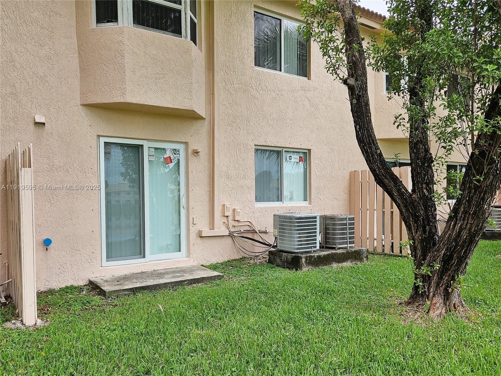 2651 Southeast 12th Road, Unit 105 Homestead, FL 33035 - Photo 21 of 24 front view of a house with a yard