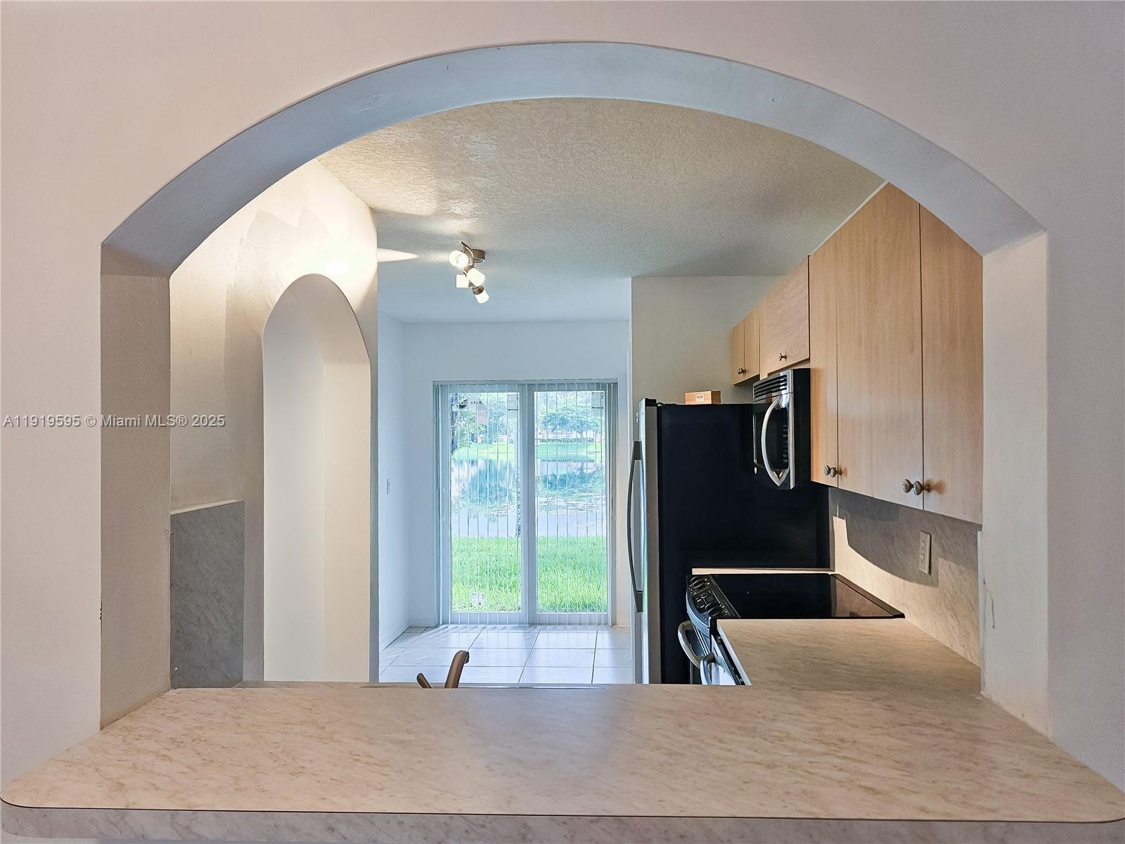 2651 Southeast 12th Road, Unit 105 Homestead, FL 33035 - Photo 5 of 24 a living room with furniture and a fireplace