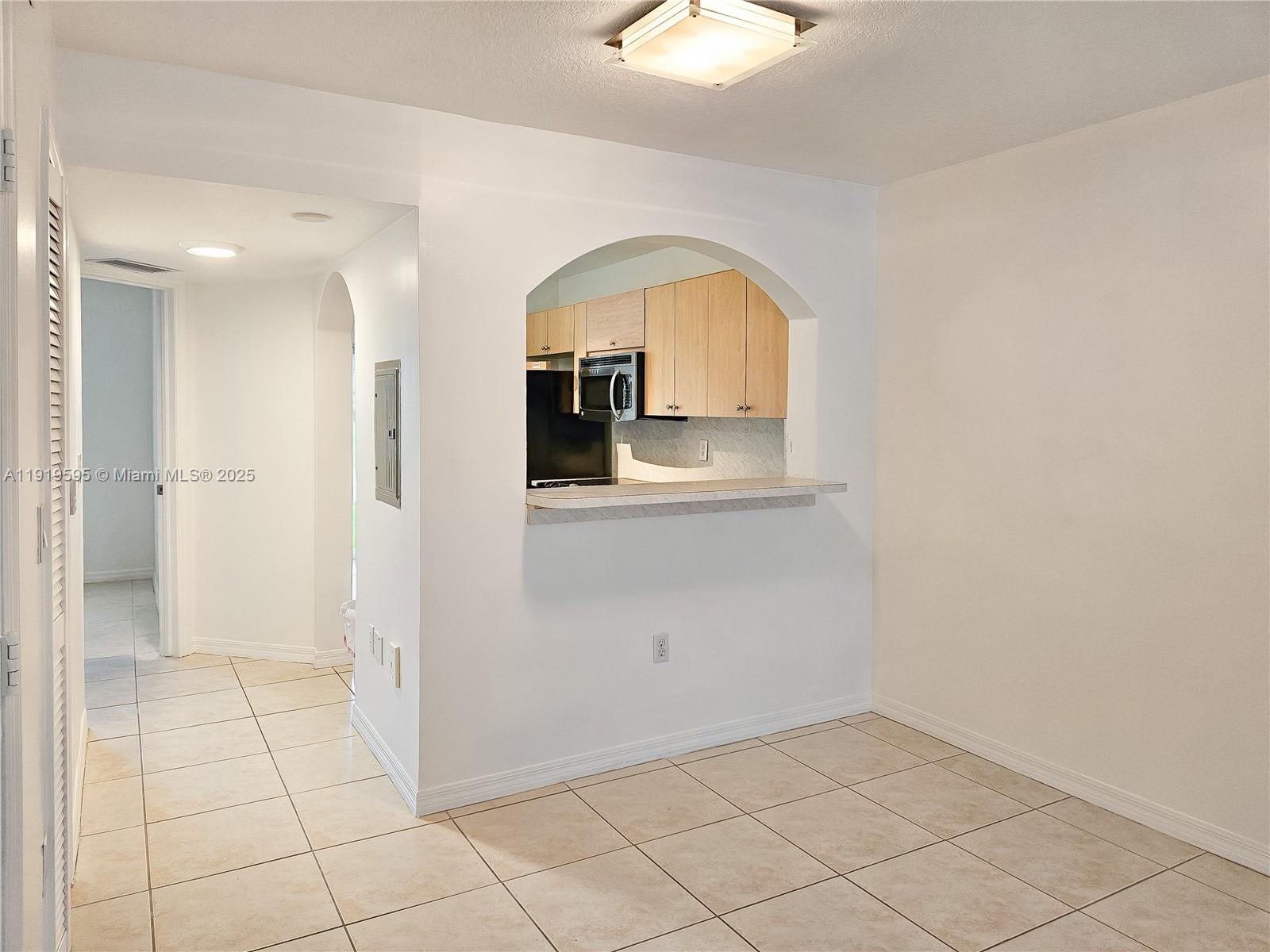 2651 Southeast 12th Road, Unit 105 Homestead, FL 33035 - Photo 6 of 24 a view of a livingroom with wooden floor and a bathroom space