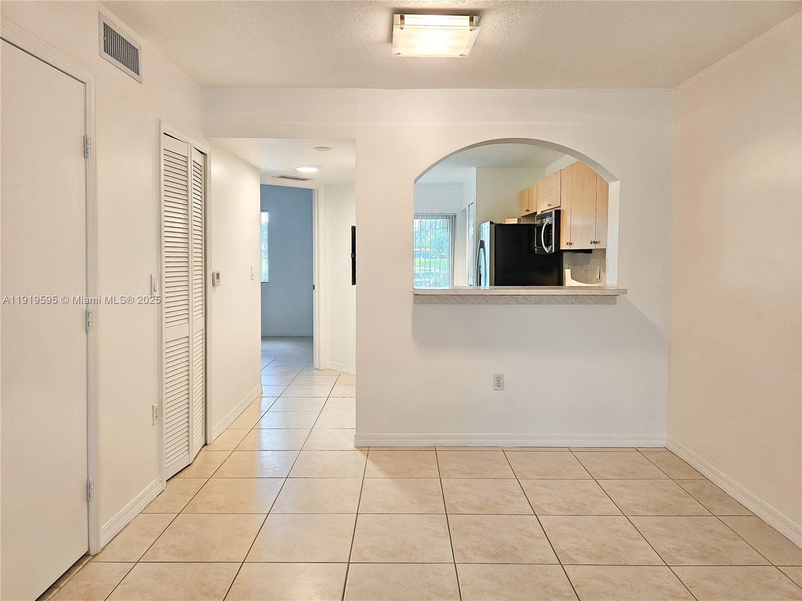 2651 Southeast 12th Road, Unit 105 Homestead, FL 33035 - Photo 7 of 24 a view of a livingroom with wooden floor and a bathroom space