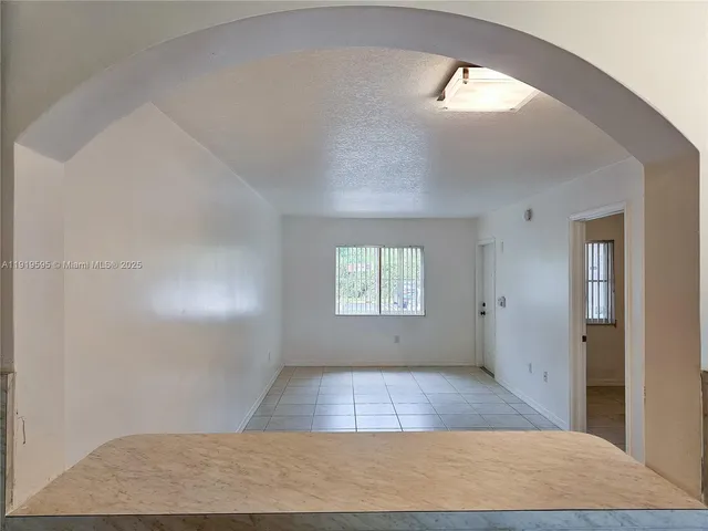 a view of room with window and hardwood floor