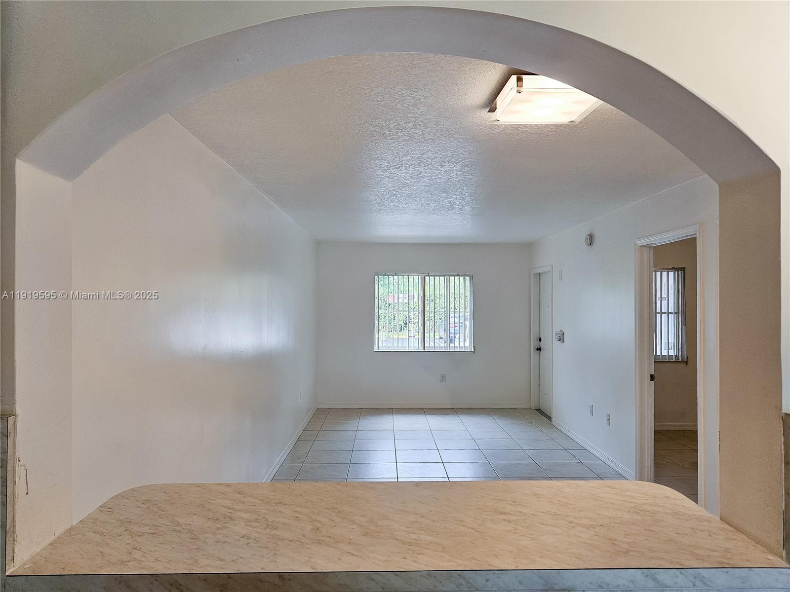 2651 Southeast 12th Road, Unit 105 Homestead, FL 33035 - Photo 8 of 24 a view of room with window and hardwood floor