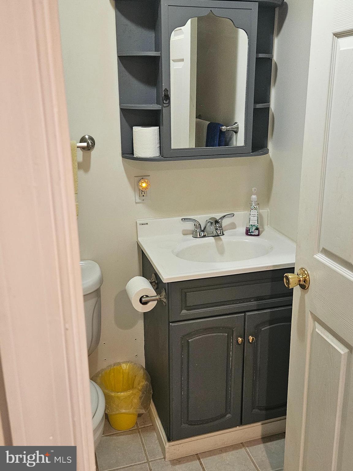 6907 Belclare Road Baltimore, MD 21222 - Photo 17 of 26 a bathroom with a sink and a mirror