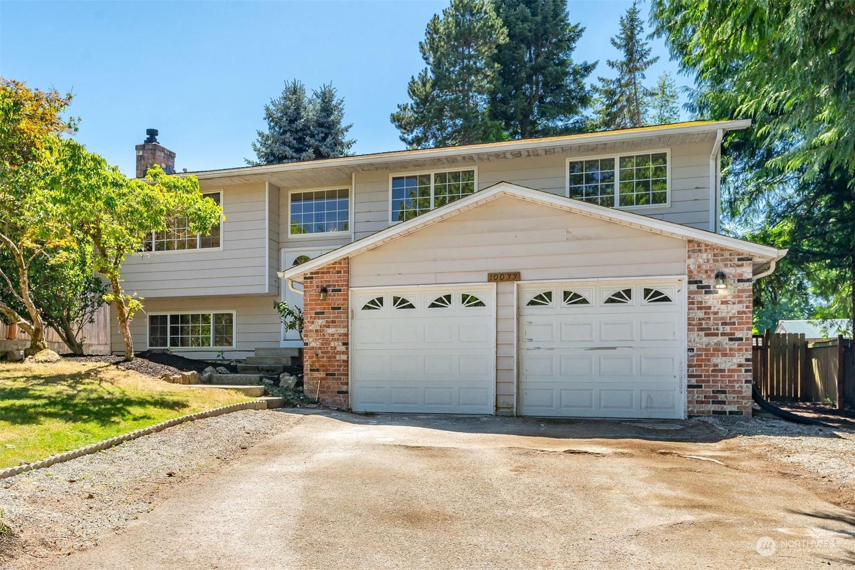 10033 Northeast 204th Street Bothell, WA 98011 - Photo 1 of 26 a view of a white house with a large space in front of it