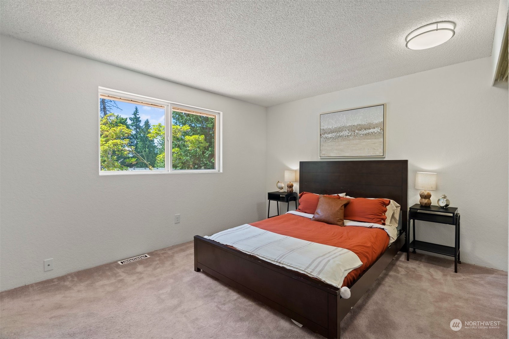 10033 Northeast 204th Street Bothell, WA 98011 - Photo 13 of 26 a bedroom with a bed and a painting on the wall