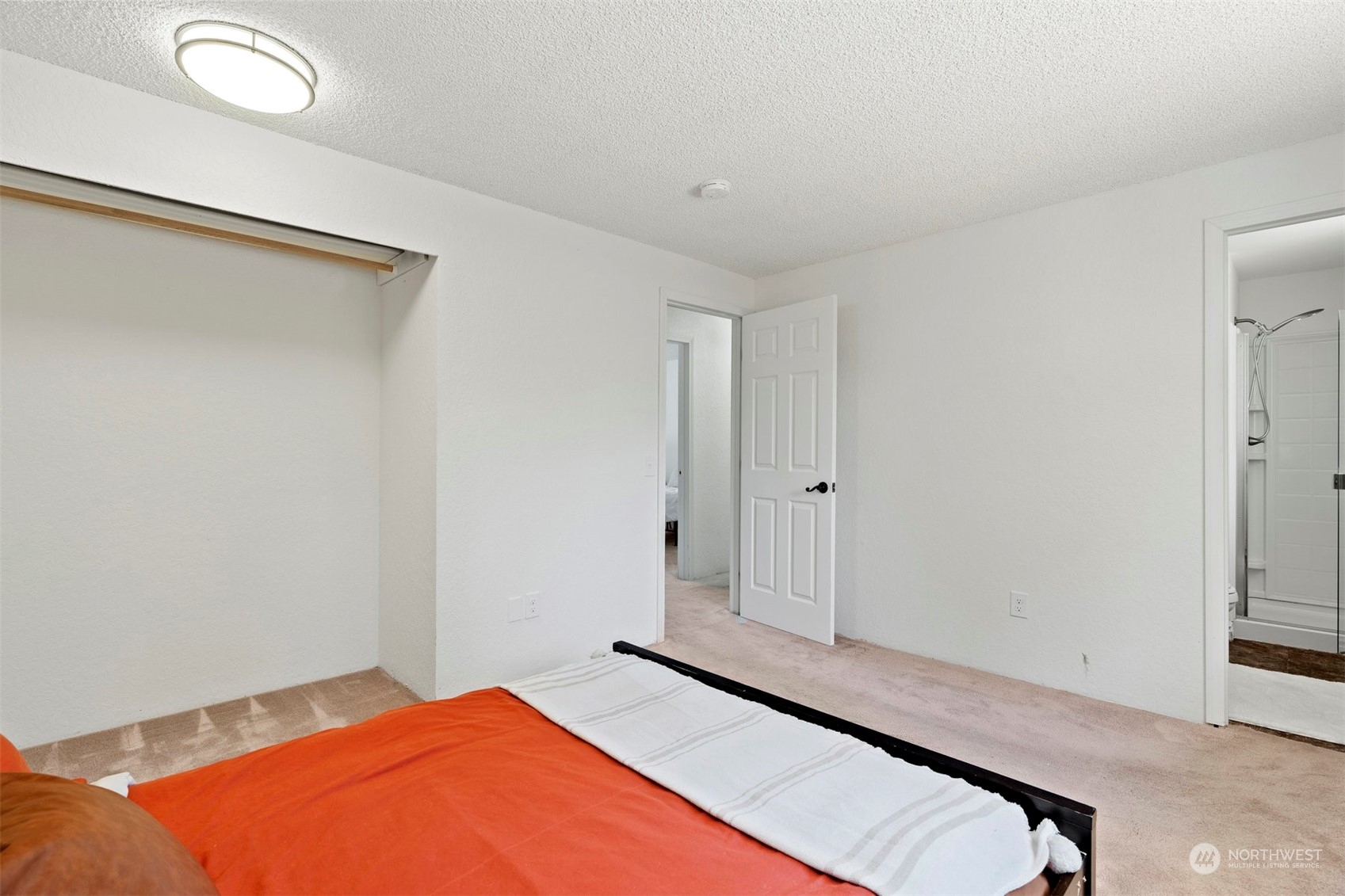 10033 Northeast 204th Street Bothell, WA 98011 - Photo 14 of 26 a bedroom with a bed and a window