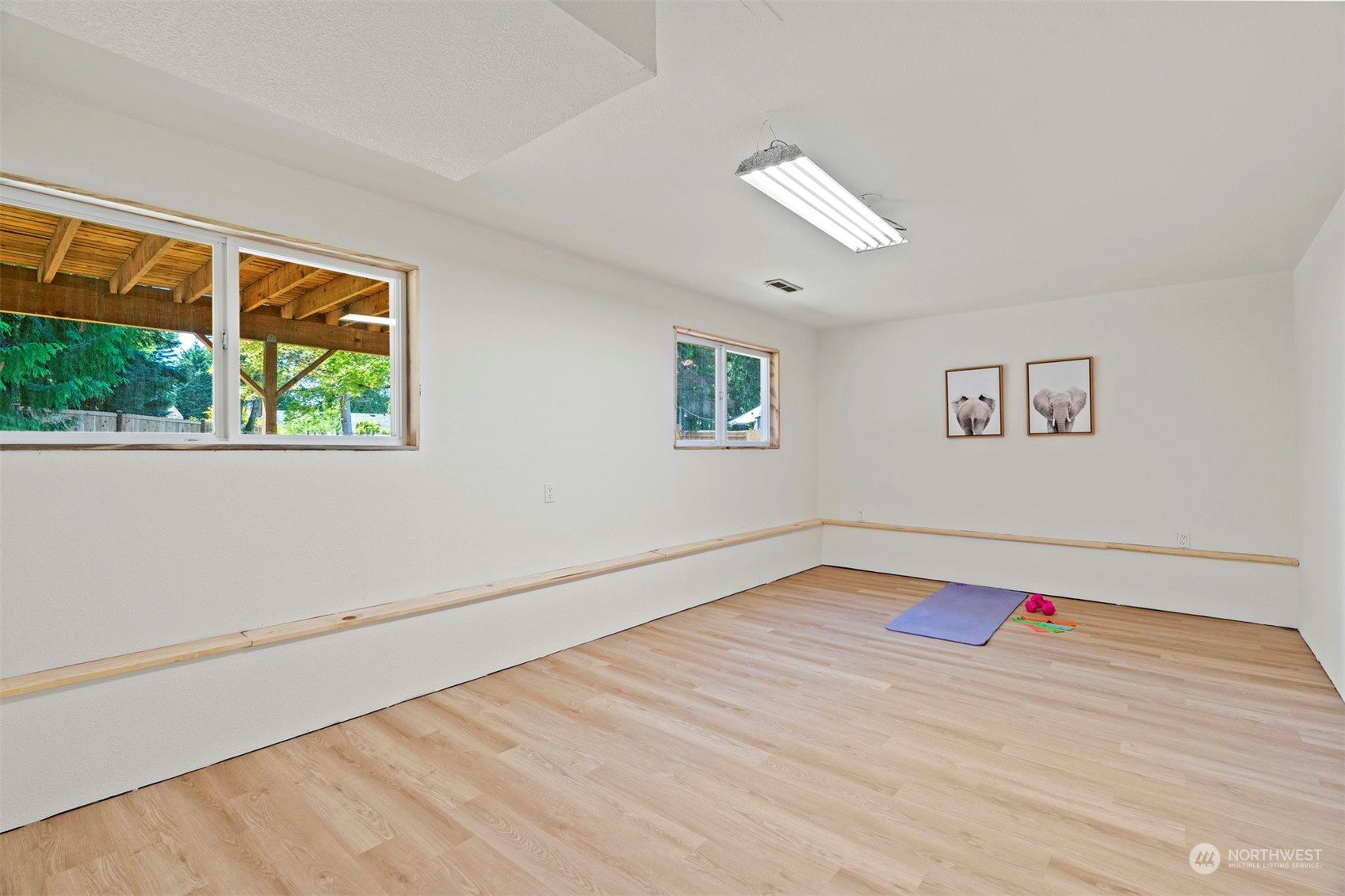 10033 Northeast 204th Street Bothell, WA 98011 - Photo 24 of 26 a view of empty room with wooden floor and fan
