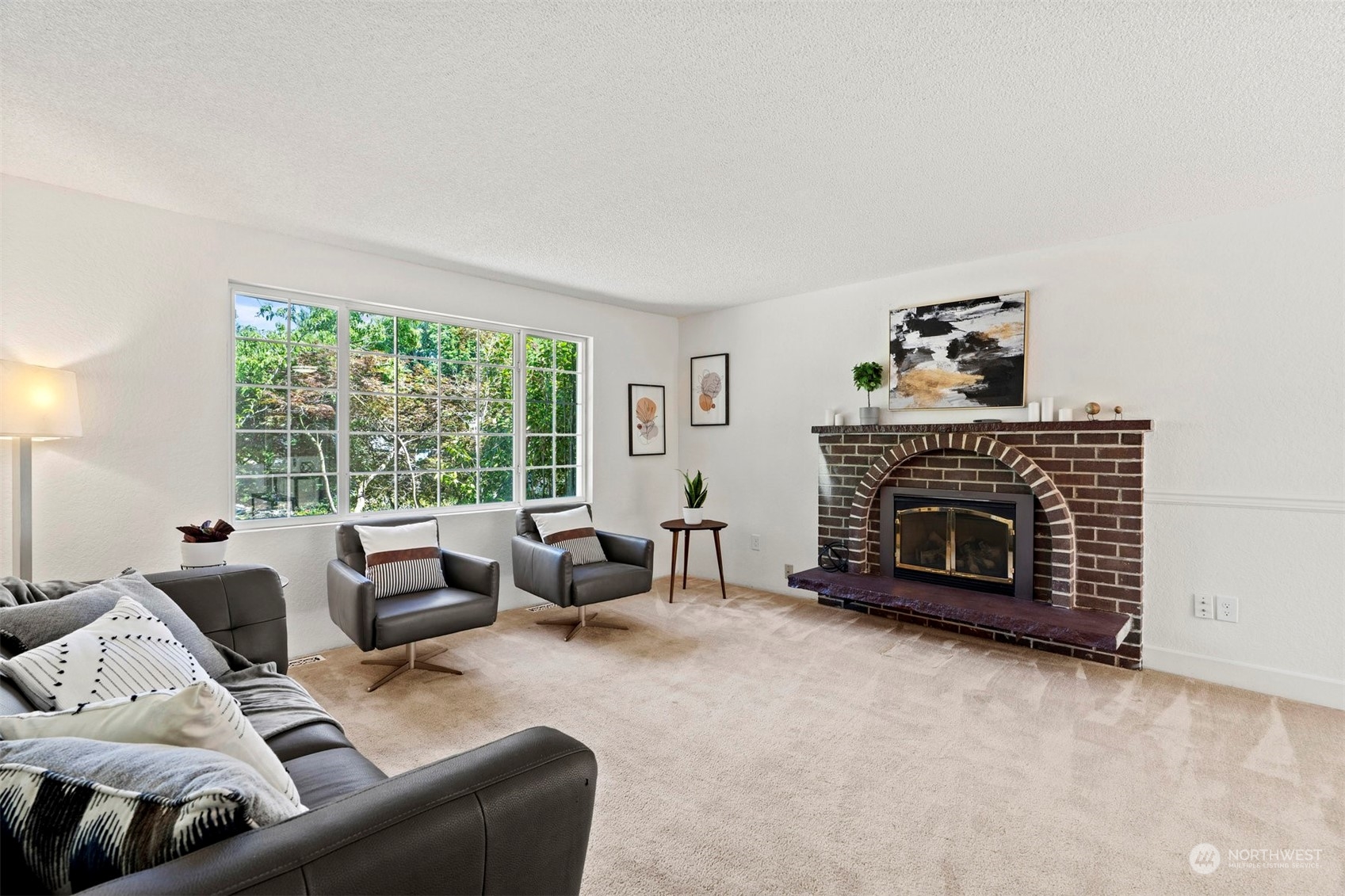 10033 Northeast 204th Street Bothell, WA 98011 - Photo 3 of 26 a living room with furniture a fireplace and a large window