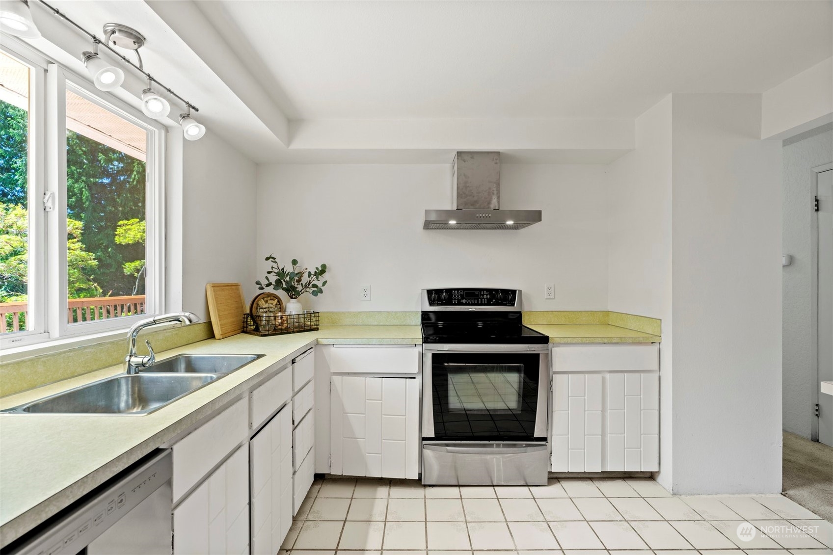 10033 Northeast 204th Street Bothell, WA 98011 - Photo 7 of 26 a kitchen with a sink stove and cabinets