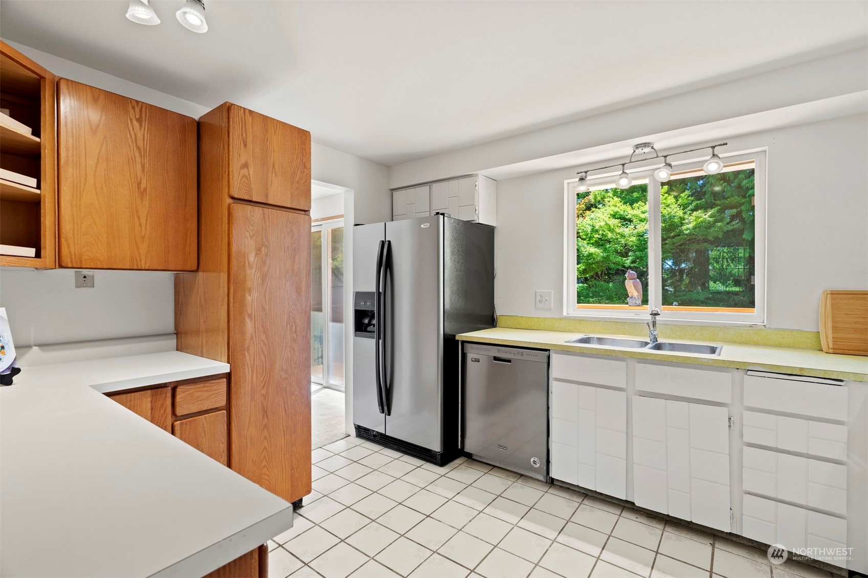 10033 Northeast 204th Street Bothell, WA 98011 - Photo 8 of 26 a kitchen with stainless steel appliances a refrigerator sink and cabinets