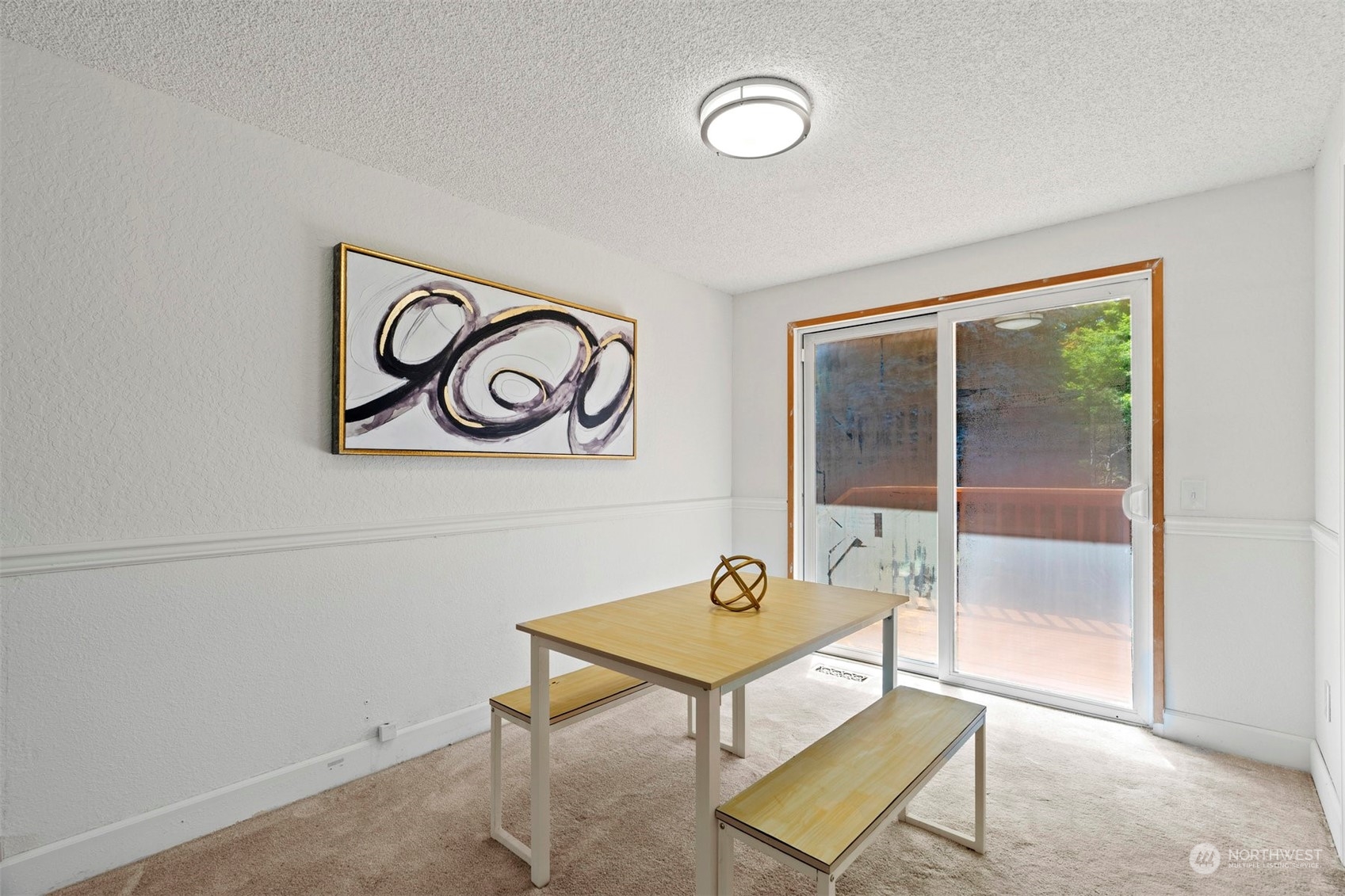 10033 Northeast 204th Street Bothell, WA 98011 - Photo 9 of 26 a room with table and glass door