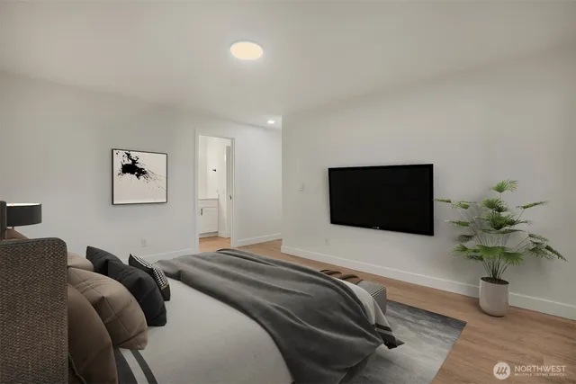 a bedroom with a bed and a flat screen tv