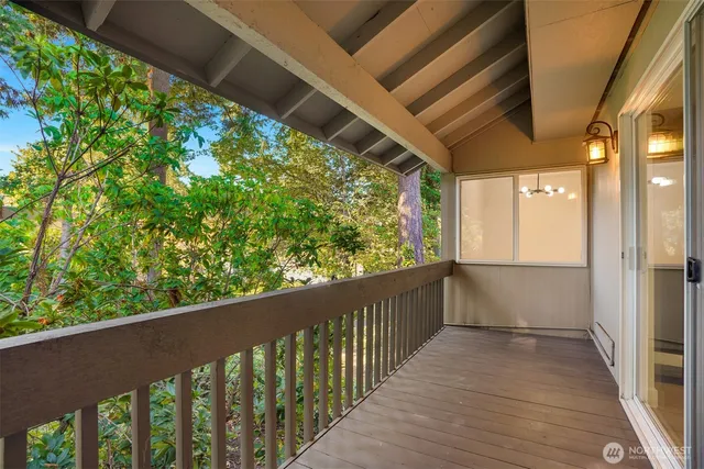 a view of a balcony with wooden floor