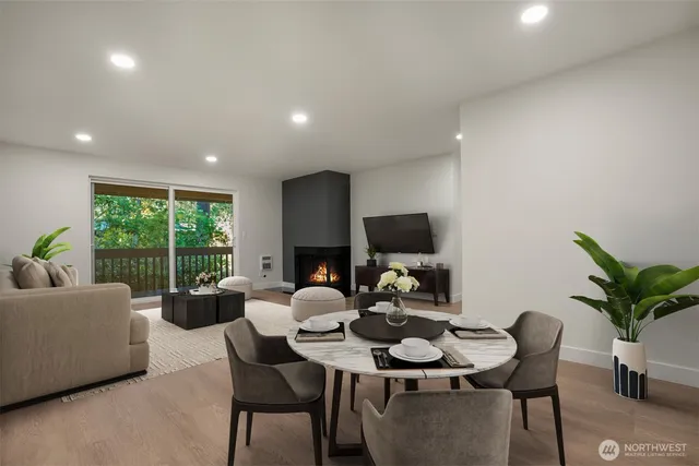 a living room with furniture a large window and a flat screen tv