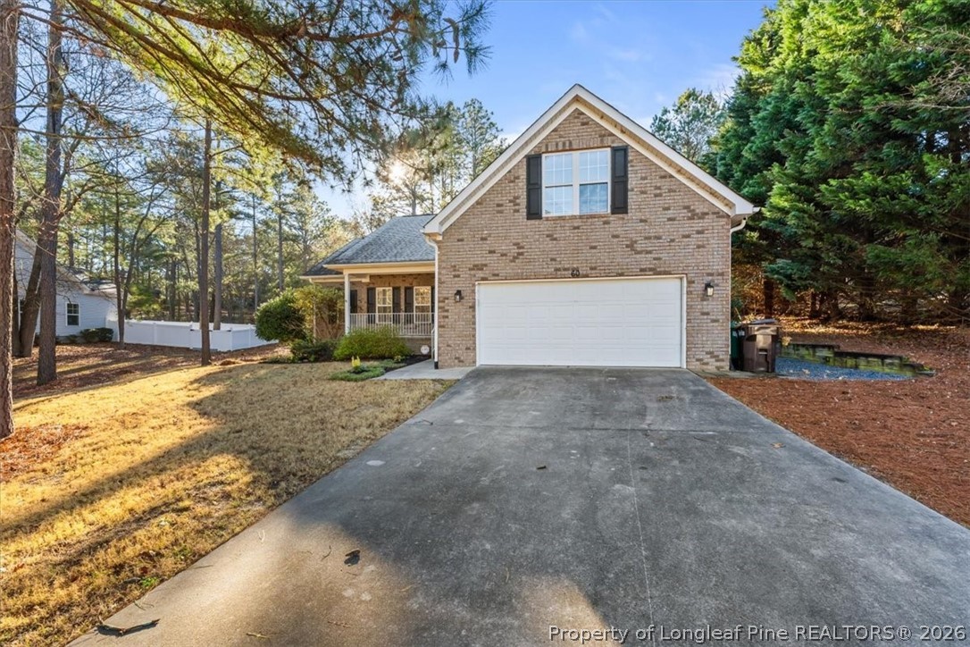 60 Spring Lake Drive Pinehurst, NC 28374 - Photo 2 of 42 a front view of a house with a yard and garage