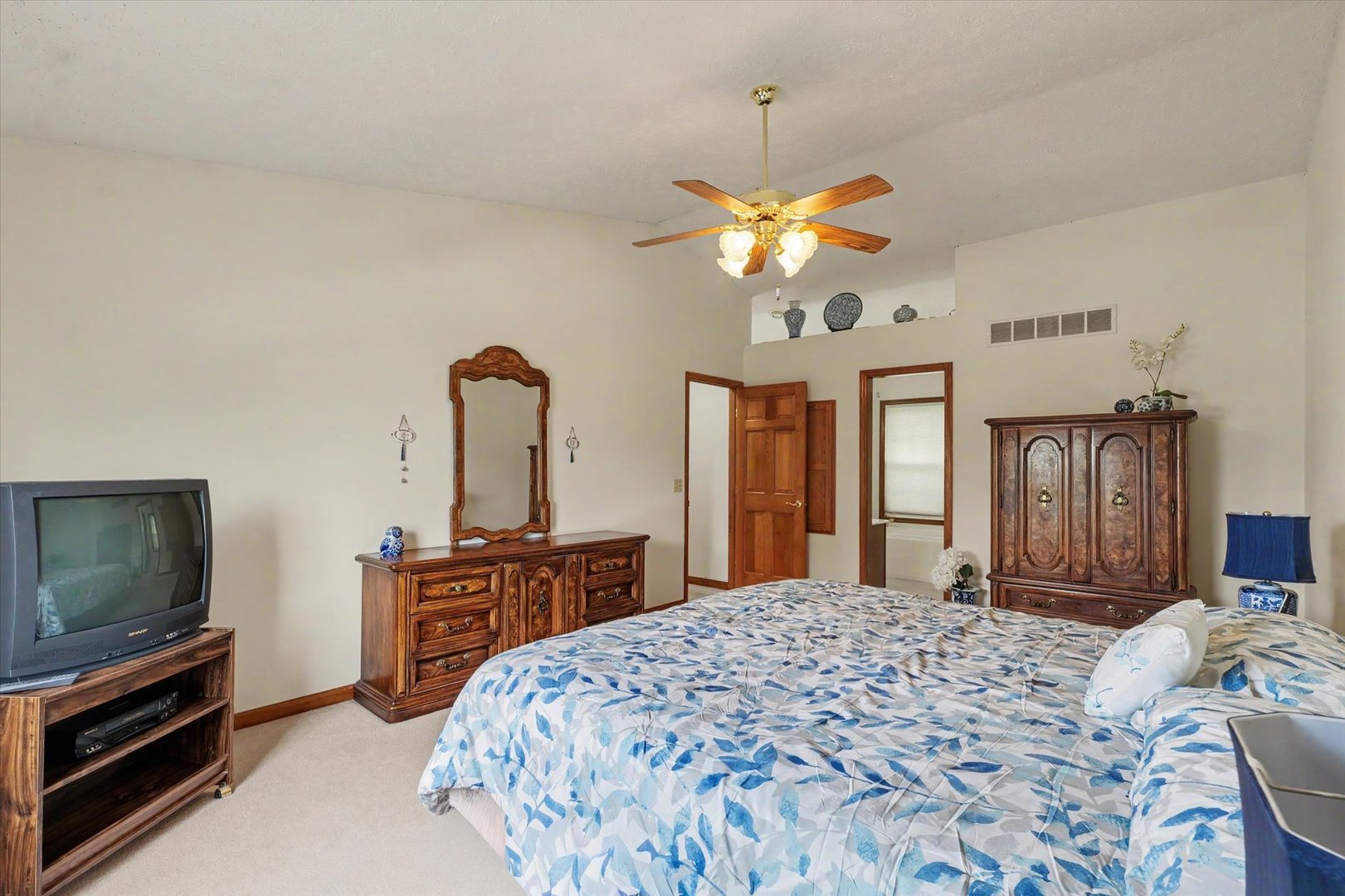 4409 Copper Ridge Road Champaign, IL 61822 - Photo 23 of 40 a bedroom with a bed dresser and a flat tv screen