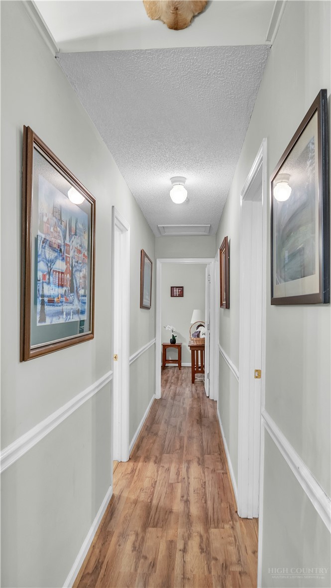 117 Rhododendron Drive Beech Mountain, NC 28604 - Photo 20 of 33 a view of a hallway with wooden floor and furniture