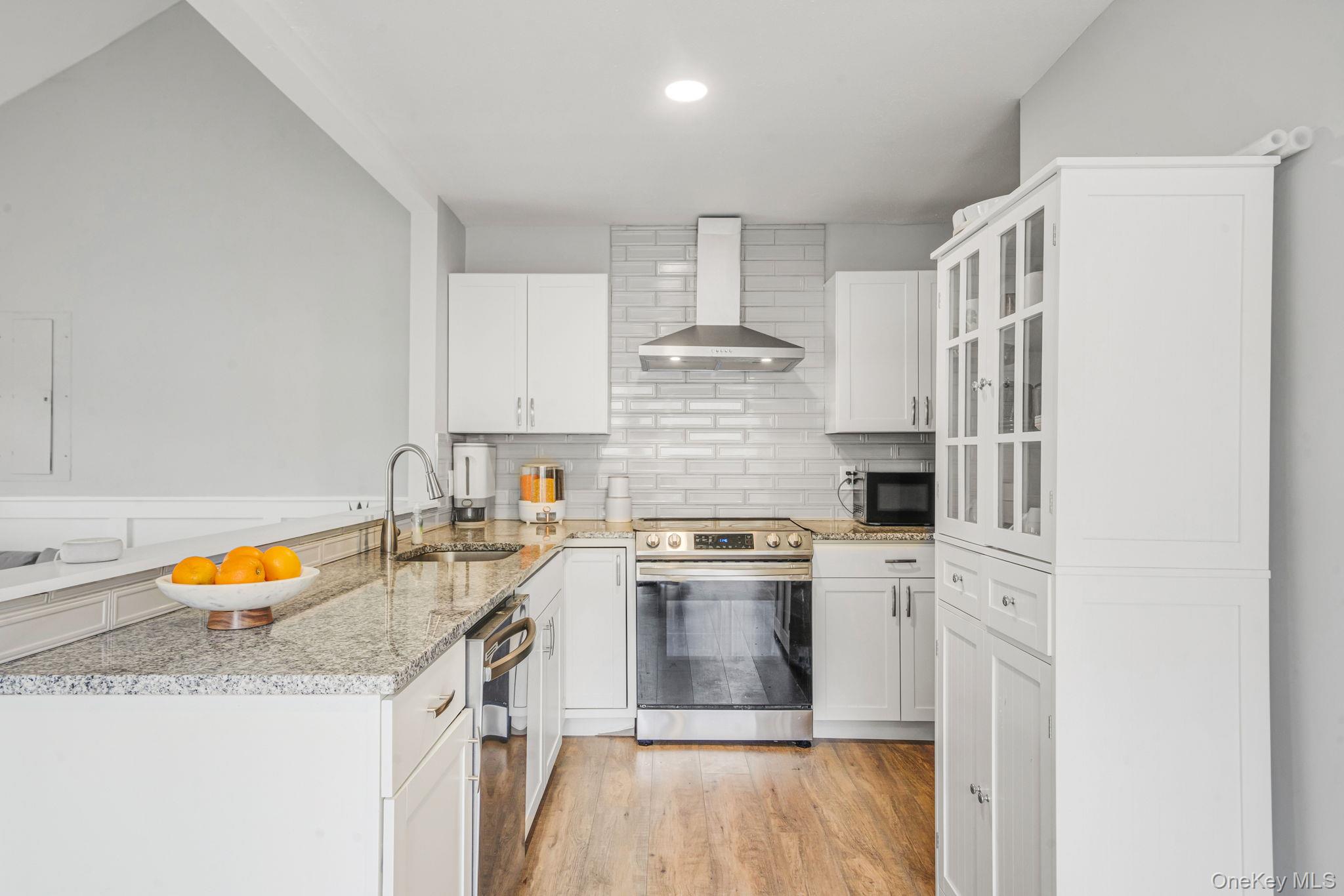 332 Commack Road Shirley, NY 11967 - Photo 9 of 25 a kitchen with stainless steel appliances granite countertop a stove and a refrigerator