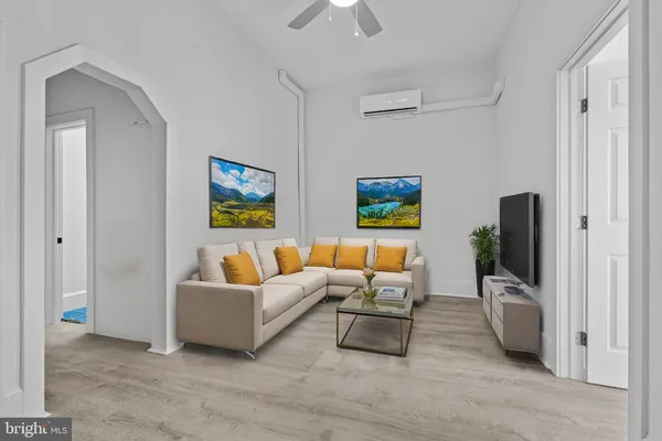 a living room with furniture and a flat screen tv