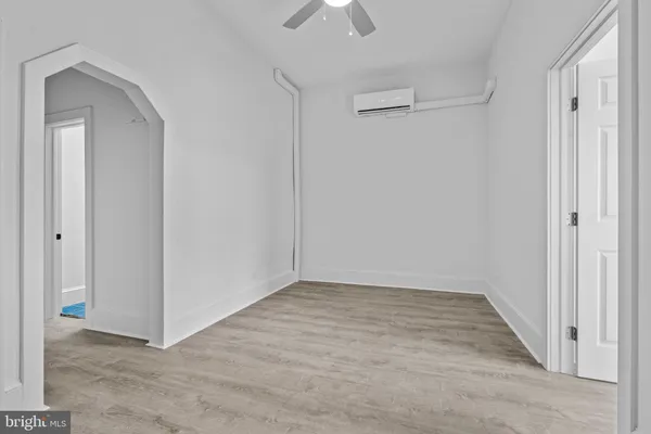 a view of an empty room with a ceiling fan
