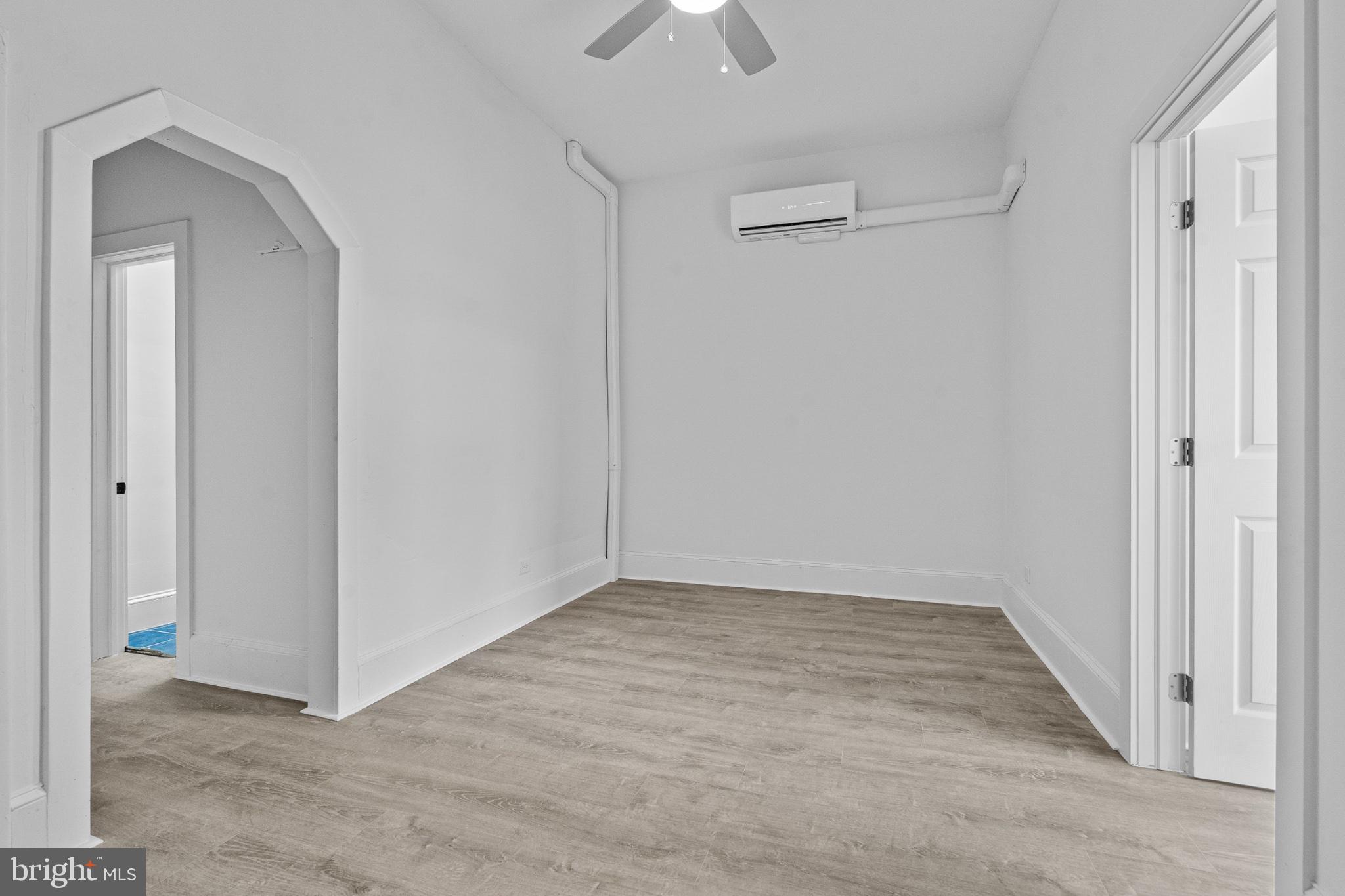 1308 West Lexington Street, Unit 3F Baltimore, MD 21223 - Photo 8 of 14 a view of an empty room with a ceiling fan
