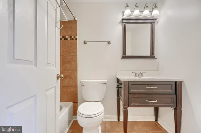 a bathroom with a toilet a sink and a mirror