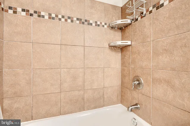 a bathroom with a bathtub and shower