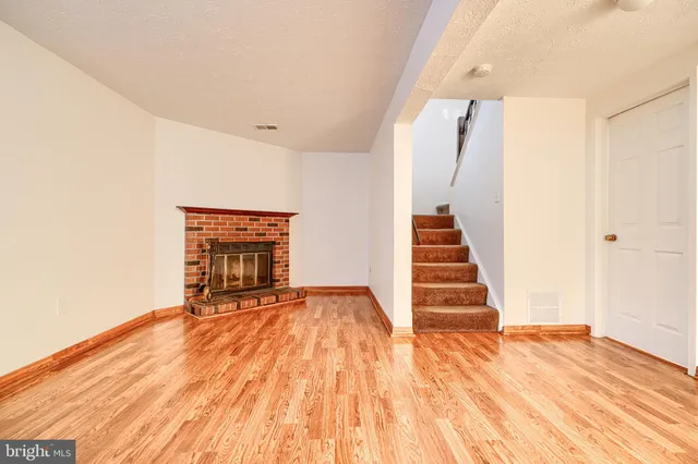a view of a bedroom with wooden floor and staircase