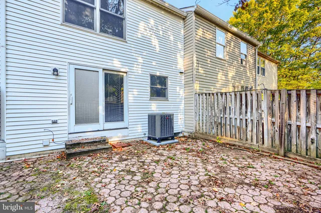 a view of a house with wooden fence