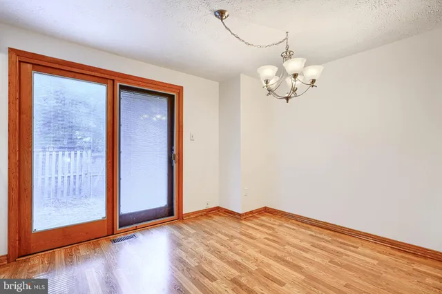 a view of a chandelier fan and wooden floor