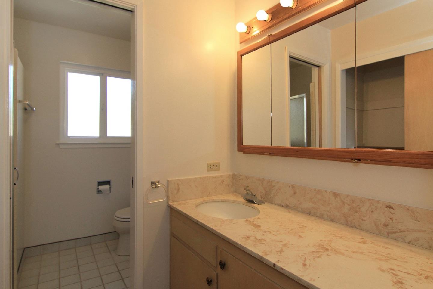 3092 Valdez Road Pebble Beach, CA 93953 - Photo 11 of 17 a bathroom with a granite countertop sink and a mirror