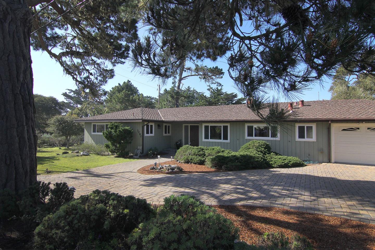 3092 Valdez Road Pebble Beach, CA 93953 - Photo 5 of 17 a front view of a house with a yard and potted plants