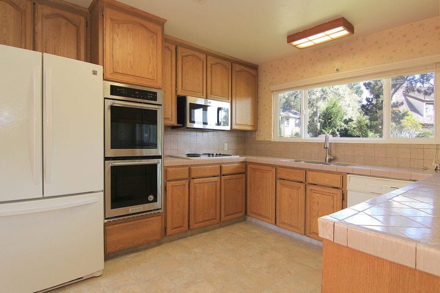 3092 Valdez Road Pebble Beach, CA 93953 - Photo 9 of 17 a kitchen with stainless steel appliances granite countertop a refrigerator sink and stove